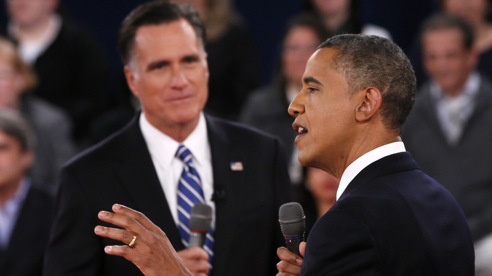 U.S. President Barack Obama (R) speaks as Republican presidential nominee Mitt Romney (L) listens during the second U.S. presidential debate in Hempstead, New York, October 16, 2012. 