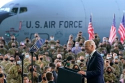 President Joe Biden speaks to American service members at RAF Mildenhall in Suffolk, England, June 9, 2021, after arriving in Europe for meetings with U.S. allies and Russian President Vladimir Putin.