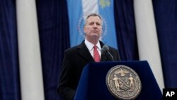 New York City Mayor Bill de Blasio speaks after being sworn in during the public inauguration ceremony at City Hall in New York, Jan. 1, 2014. 