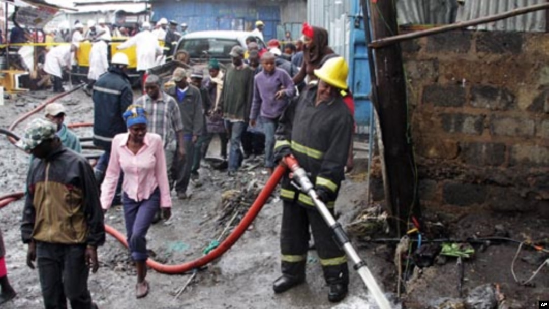 Rescuers at the scene of the pipeline explosion in Nairobi's Mukuru Sinai slums on Sept. 12, 2011.