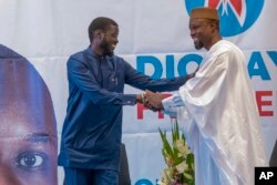 FILE—Senegal's top opposition leader Ousmane Sonko, right, and his key ally Bassirou Diomaye Faye address supporters in Dakar, Senegal, March 15, 2024.