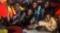 In this Thursday, July 28, 2016 photo, about 150 sub-Saharan refugees and migrants receive life jackets as they aboard an overcrowded rubber boat and wait to be assisted by an NGO during a rescue operation on the Mediterranean Sea, about 23 kilometers (14 miles) north of Sabratha, Lybia. 