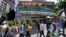 FILE - Pedestrians walk past a Whole Foods Market, just down the street from the headquarters of Amazon, in Seattle, Washington, July 11, 2017.