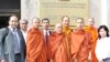 Thach Ngoc Thach, left and newly re-ordained monk Tim Sakhorn, middle, drops by VOA Khmer while on a visit in the US.
