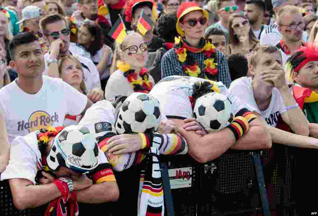 Supporters of the German national football team react as they attend a public viewing event at the Fanmeile in Berlin to watch the 2018 World Cup Group F football match between South Korea and Germany.