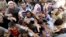 Displaced Iraqis from the Yazidi community gather for humanitarian aid at the Syria-Iraq border at Feeshkhabour border point, northern Iraq, Aug. 10, 2014.