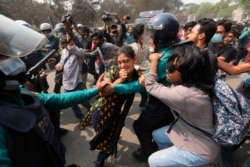 FILE - Hundreds of Bangladeshi students clash with police during a protest to denounce the death in prison of writer Mushtaq Ahmed, in Dhaka, Bangladesh, March 1, 2021.