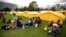 Venezuelan migrants sit upon arrival to a new, refugee-style camp set up by the government in Bogota, Colombia, Nov. 13, 2018. 