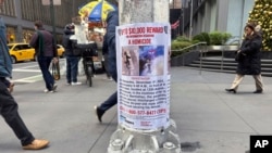 A reward poster hangs on a light pole outside the New York Hilton Midtown Hotel in New York on Dec. 5, 2024, where Brian Thompson, the CEO of UnitedHealthcare, was fatally shot on Wednesday.