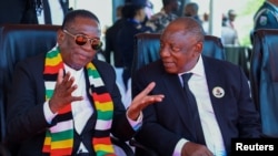 Zimbabwe's President Emmerson Mnangagwa chats with South Africa's President Cyril Ramaphosa on the day of the burial of Sam Nujoma, who became Namibia's first democratically elected president, at Namibia's Heroes' Acre, near Windhoek, March 1, 2025.