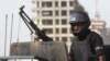 FILE - A policeman stands guard in Karachi, Pakistan, May 14, 2015. Police said Thursday that IS commander Kamran Aslam, also known as Kamran Gujjar, was killed in a raid in Karachi’s Ettihad Town neighborhood.