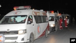 Photo released by the Syrian official news agency SANA, shows members of the Syrian Arab Red Crescent gathering near their ambulances during a human evacuation of sick and wounded people from the eastern Ghouta, near Damascus, Dec. 28, 2017. 