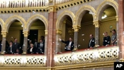 Opposition lawmakers throw flyers from the balcony at the start of the plenary session of the parliament in Budapest, Hungary, Dec. 12, 2018.