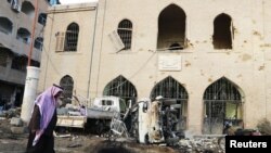 A man walks past Raqqa Museum, which activists said was damaged by airstrikes by forces loyal to Syria's President Bashar al-Assad, in Islamic State-controlled Raqqa, eastern Syria, November 25, 2014. 