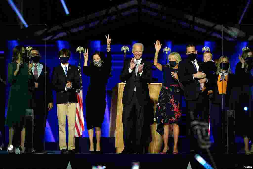 Democratic 2020 U.S. presidential nominee Joe Biden is accompanied on the stage by his wife Jill, and members of their family, after speaking during his election rally.