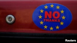 A car sticker with a logo encouraging people to leave the EU is seen on a car, in Llandudno, Wales, February 27, 2016.