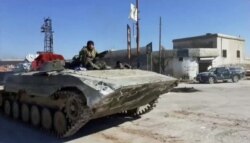 Syrian army soldiers advance on the town of Kfar Nabl, Syria, in this still image taken from a video obtained by Reuters and shot on March 2, 2020.