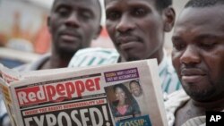 FILE - A Ugandan reads a copy of the "Red Pepper" tabloid newspaper in Kampala, Feb. 25, 2014.