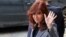 Former Argentine President Cristina Fernandez de Kirchner waves as she leaves the Federal Justice building in Buenos Aires, Argentina, Sept. 18, 2018. 