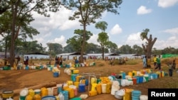 Empty jerrycans are arranged by refugees from Burundi who fled the ongoing violence and political tension at a water tap at the Nyarugusu refugee camp in western Tanzania, May 28, 2015. 