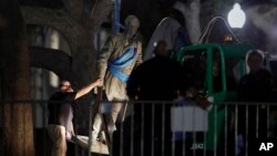 A statue of Confederate Gen. Robert E. Lee is removed from the University of Texas campus, Aug. 21, 2017, in Austin, Texas.