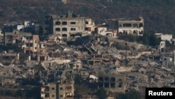 
Une vue montre des bâtiments résidentiels détruits à Rmyach, dans le sud du Liban, alors que se poursuivent les hostilités entre le Hezbollah et les forces israéliennes. Photo prise depuis Sasa, dans le nord d'Israël, le 26 octobre 2024.