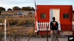 A law enforcement vehicle leaves the Bonanza Creek Film Ranch in Santa Fe, N.M. Friday, Oct. 22, 2021. Actor Alec Baldwin fired a prop gun on the set of a Western being filmed at the ranch on Thursday, Oct. 21, killing the cinematographer, officials said.