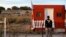 A law enforcement vehicle leaves the Bonanza Creek Film Ranch in Santa Fe, N.M. Friday, Oct. 22, 2021. Actor Alec Baldwin fired a prop gun on the set of a Western being filmed at the ranch on Thursday, Oct. 21, killing the cinematographer, officials said.