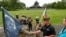 President Donald Trump stands with Vice President Mike Pence and Gen Omar Jones, Commanding General at Joint Force Headquarters, attend Memorial Day ceremony, May 25, 2020. 