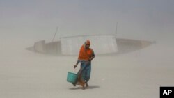Une femme ramenant l'eau dans un seau
