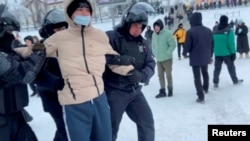 Police officers detain a demonstrator protesting the court verdict against a leading rights activist in the city of Ufa in the Republic of Bashkortostan, Russia, in this still image from video, Jan. 19, 2024.