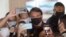 Brazil's President Jair Bolsonaro poses for a picture with supporters amid the COVID-19 outbreak in Brasilia on May 23, 2020.