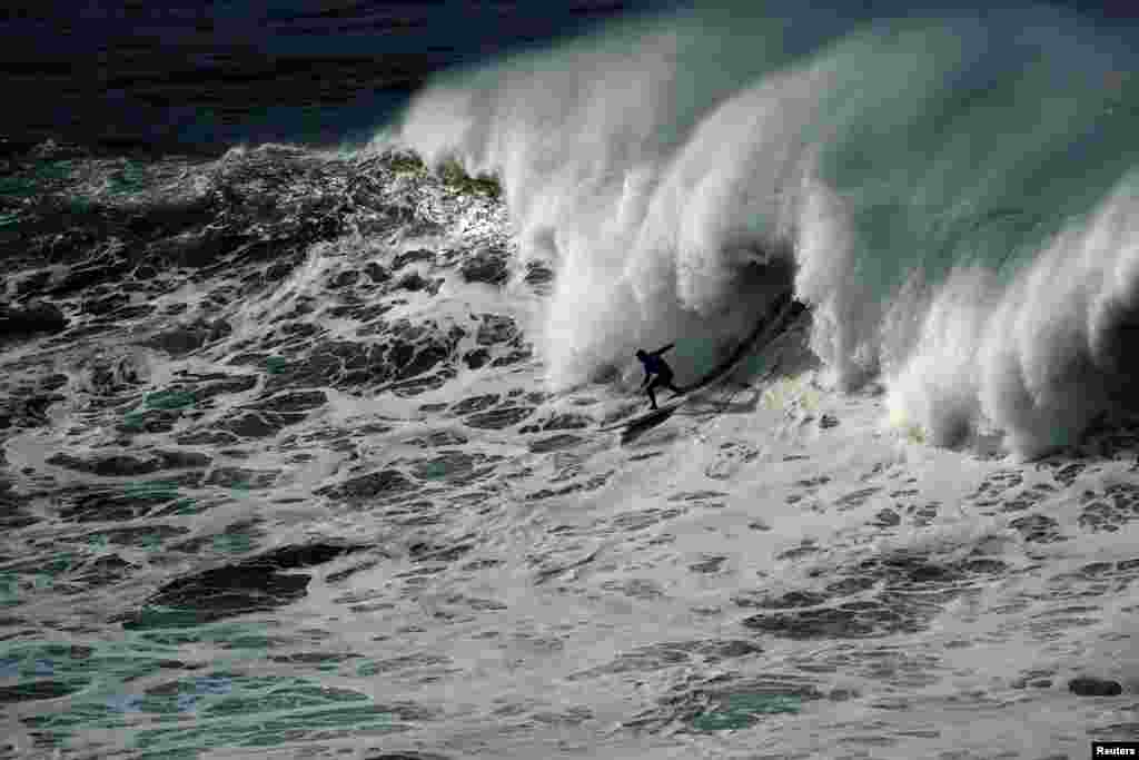 A surfer rides a wave during the Punta Galea Big Wave Challenge in Punta Galea, Getxo, near Bilbao, Spain.