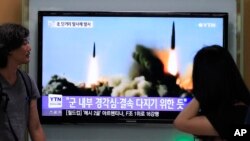 FILE - South Koreans watch a TV news program showing a missile launch by North Korea, at Seoul Railway Station, Seoul, June 26, 2014.