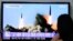 South Koreans watch a TV news program showing the missile launch conducted by North Korea, at Seoul Railway Station, Seoul, June 26, 2014.