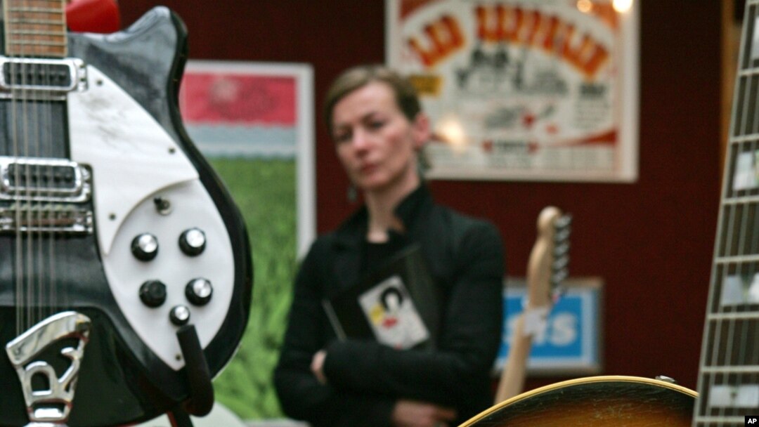 FILE - A 1963 Gibson J-160E guitar donated by Noel Gallagher is seen at Christie's Auction House in west London, Sept, 26, 2005. The acoustic guitar once owned by John Lennon has been sold for $2.4 million by Julien's Auctions in Los Angeles to an undisclosed buyer. 