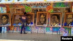 Congolese artist Patrick Cikuru Cirimwami applies finishing touches on pictures of Congolese leaders, made from plastic waste, collected near the Ruzizi I hydroelectric plant, in Bukavu, eastern Democratic Republic of Congo on December 15, 2022. (REUTERS/Crispin Kyalangalilwa)