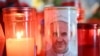 Candles are lit at the statue of John Paul II outside the Gemelli University Hospital where Pope Francis is hospitalized with pneumonia, in Rome, March 4, 2025.