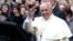 Pope Francis waves as he leaves at the end of his mass at the Church of the Most Holy Name of Jesus in Rome, Jan. 3, 2014. 