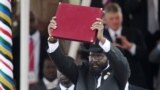 FILE PHOTO - In this photo taken on July 09, 2011, the President of South Sudan Salva Kiir waves the newly signed constitution of his country for the crowd to see during a ceremony in the capital Juba to celebrate South Sudan's independence from Sudan.