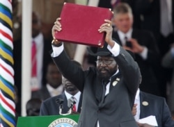 FILE PHOTO - In this photo taken on July 09, 2011, the President of South Sudan Salva Kiir waves the newly signed constitution of his country for the crowd to see during a ceremony in the capital Juba to celebrate South Sudan's independence.