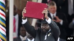 FILE PHOTO - In this photo taken on July 09, 2011, the President of South Sudan Salva Kiir waves the newly signed constitution of his country for the crowd to see during a ceremony in the capital Juba to celebrate South Sudan's independence from Sudan.