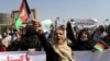 Afghan women shout slogans and wave Afghan national flags during an anti-Pakistan demonstration, near the Pakistan embassy in Kabul, Afghanistan, Sept. 7, 2021. Sign in Persian at right reads, "Pakistan Pakistan Get out from Afghanistan."