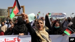 Afghan women shout slogans and wave Afghan national flags during an anti-Pakistan demonstration, near the Pakistan embassy in Kabul, Afghanistan, Sept. 7, 2021. Sign in Persian at right reads, "Pakistan Pakistan Get out from Afghanistan."