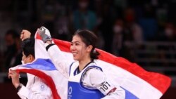 Tokyo 2020 Olympics - Taekwondo - Women's Flyweight - 49kg - Gold medal match - Makuhari Messe Hall A, Chiba, Japan - July 24, 2021. Panipak Wongphatthanakit of Thailand celebrates winning gold with the Thai national flag REUTERS/Murad Sezer