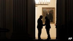 German President Frank-Walter Steinmeier, left, welcomes Social Democratic Party, SPD chairman Martin Schulz, right, at Bellevue palace for talks about a new German government in Berlin, Nov. 30, 2017. 