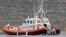 Italian Coast Guard personnel load a body bag on their patrol boat off Lampedusa island, Oct. 8, 2013. 