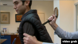 A reporter from Israel's Channel 1 is seen testing a knife proof vest in this screengrab from Twitter.