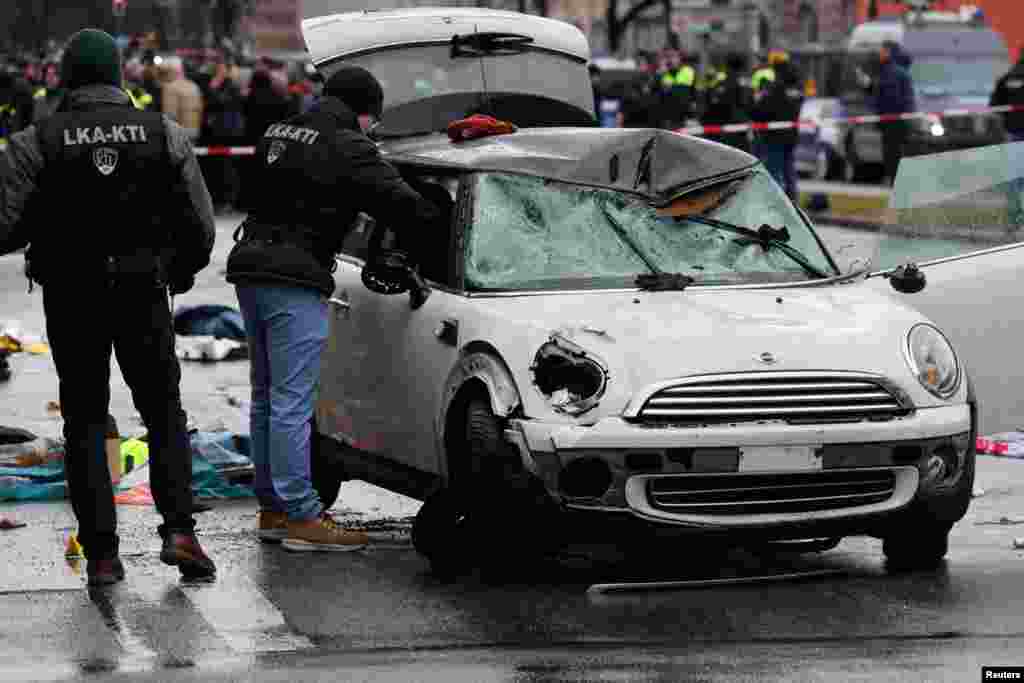 Police work at the scene where a car drove into a crowd in Munich, Germany, injuring several people.