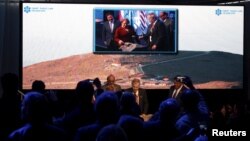 Chile's President Michelle Bachelet (C in the screen) attends the opening ceremony of the construction of The Giant Magellan Telescope (GMT) at Las Campanas hill near Vallenar town, Chile, Nov. 11, 2015.